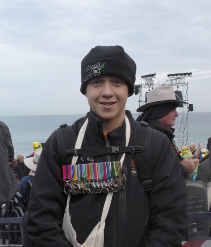 Kobi Watson wearing his grandfather’s medals at Anzac Cove 25.4.2015. Photo: K. Watson